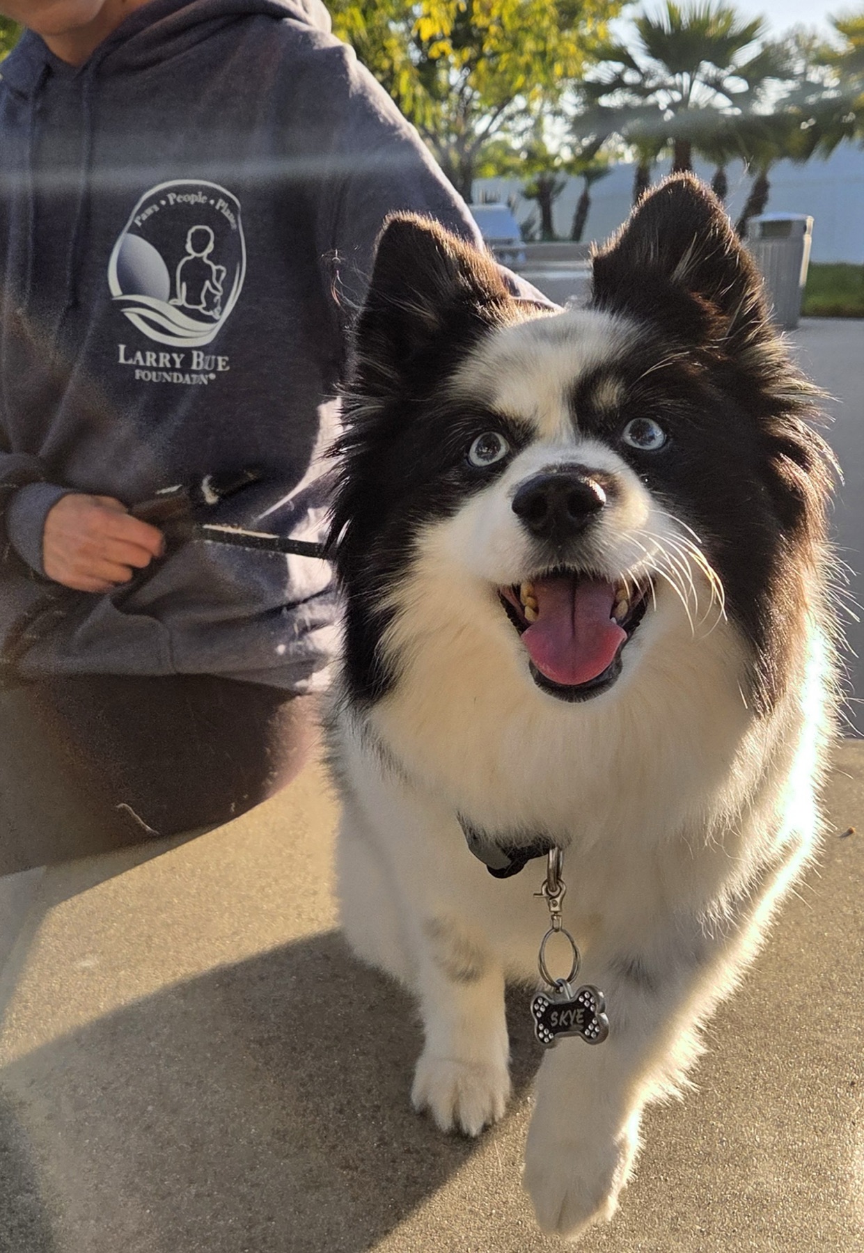 Skye smiles alongside a Larry Blue Foundation volunteer